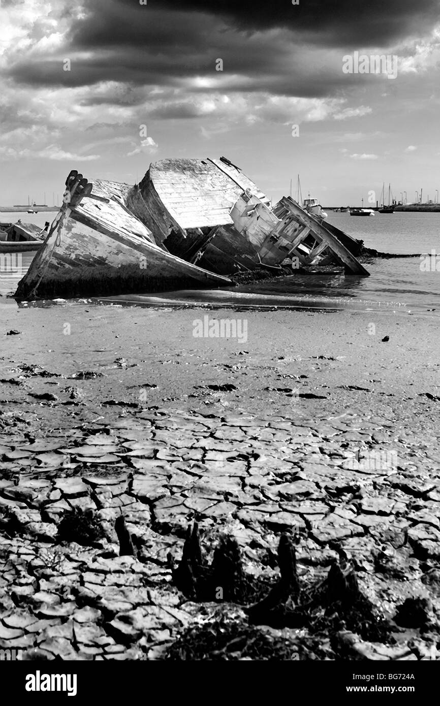 Old boat sunk in mud in estuary rotting in water Stock Photo Alamy