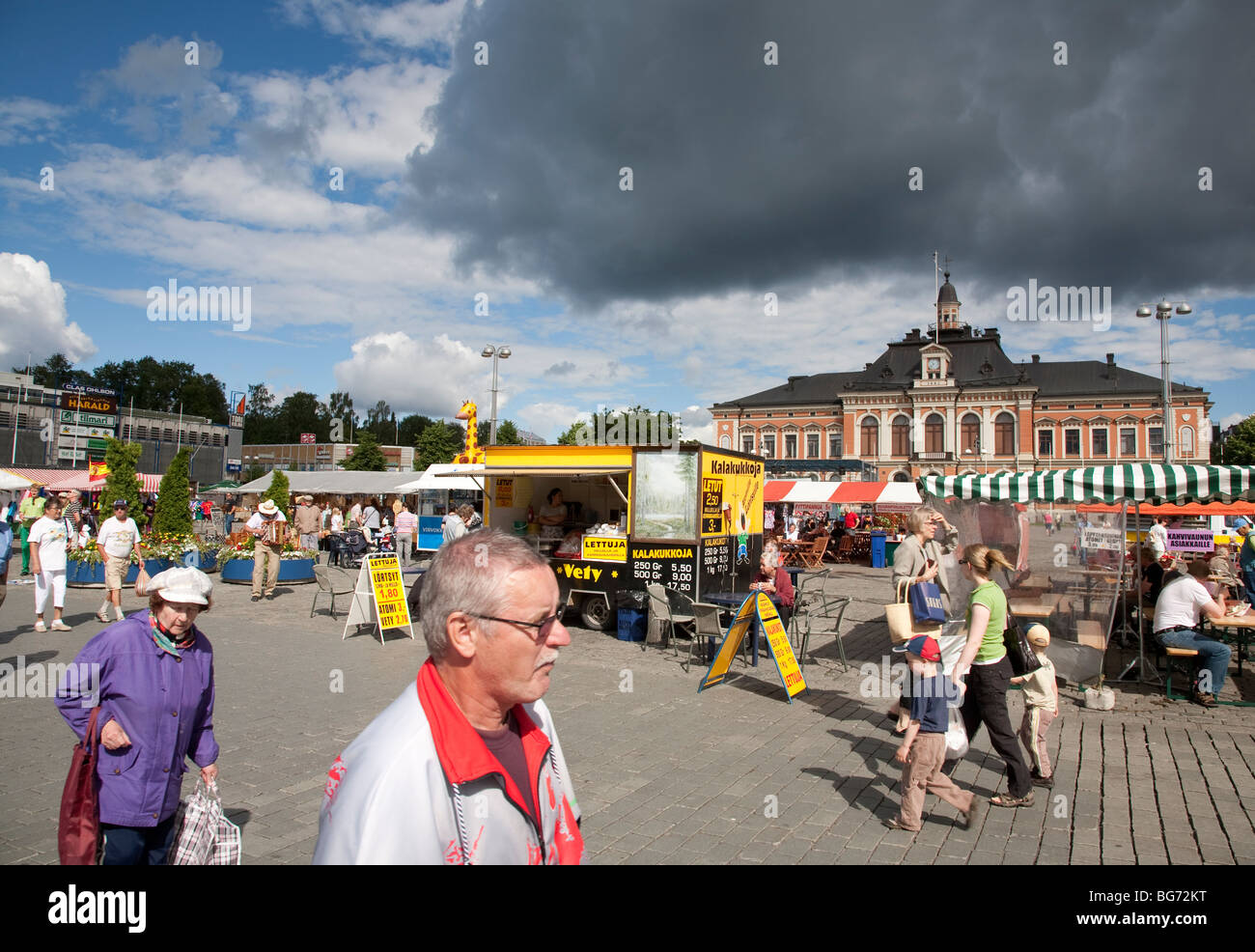 Stall holders and people at the Kuopio City Central marketplace ( Kuopion Kauppatori ), town hall at the background , Finland Stock Photo