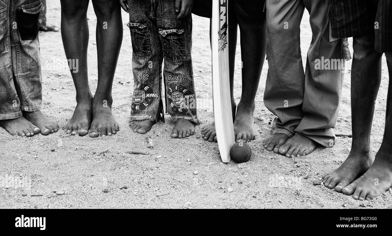 Indian boys with cricket bat and ball. Nallaguttapalli, Andhra Pradesh, India. Monochrome Stock Photo