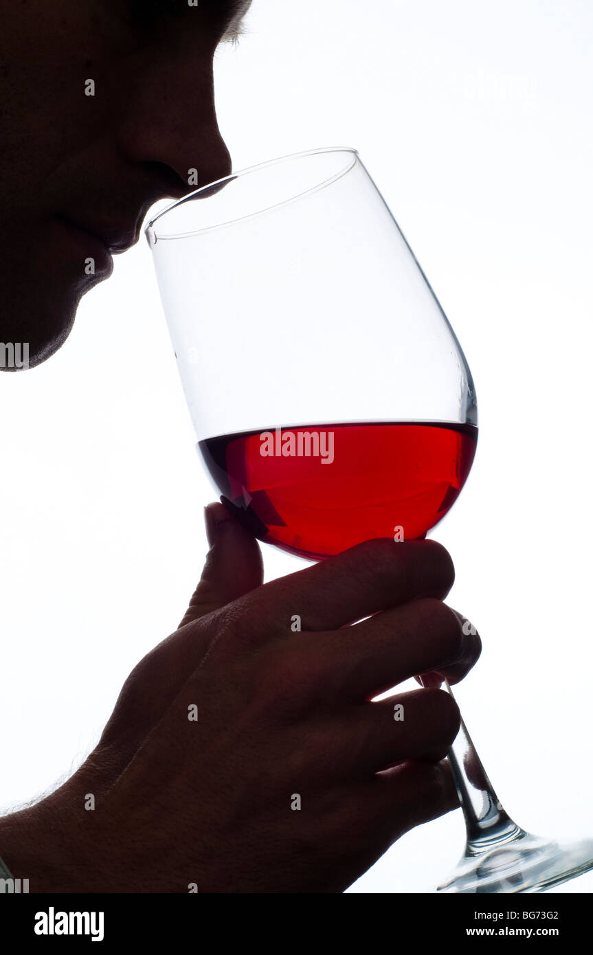 man smelling glass of red wine Stock Photo - Alamy