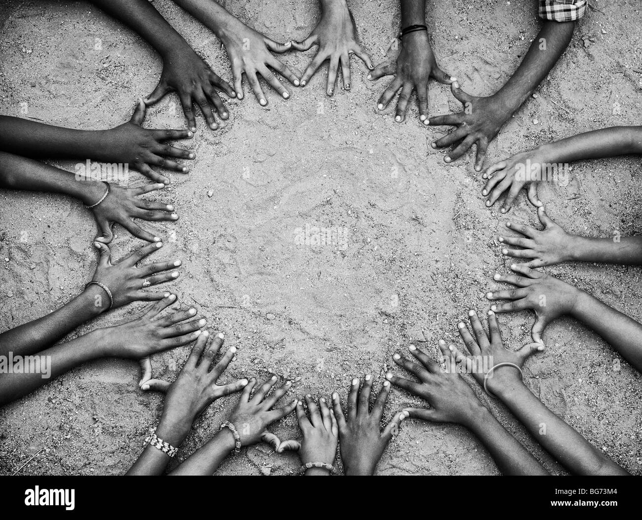 Childrens hands and fingers forming a circle. India. Black and White Stock Photo