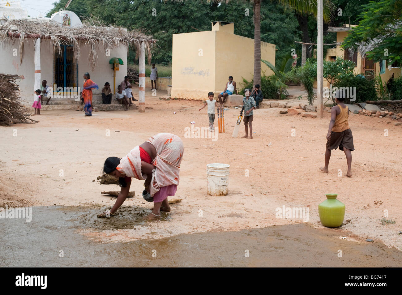 Indian custom of a woman spreading watered down cow dung outside the