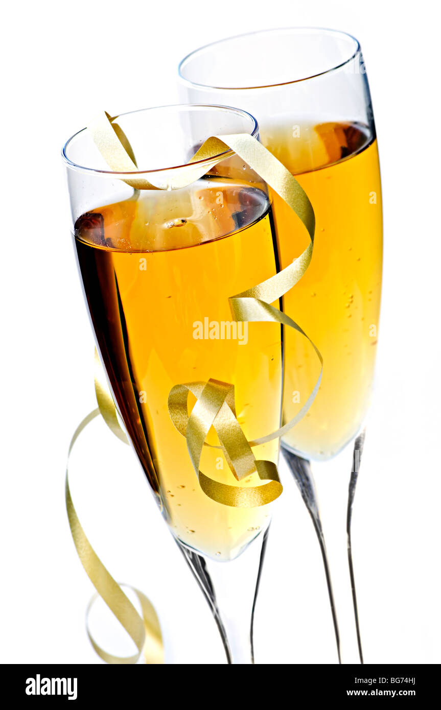 Two full champagne flutes with sparkling wine and ribbon isolated Stock