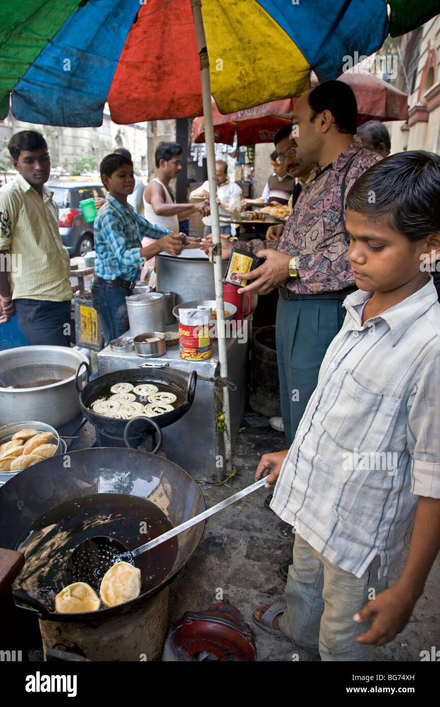 Boy frying rotis (indian bread). Calcutta (Kolkata). India Stock Photo