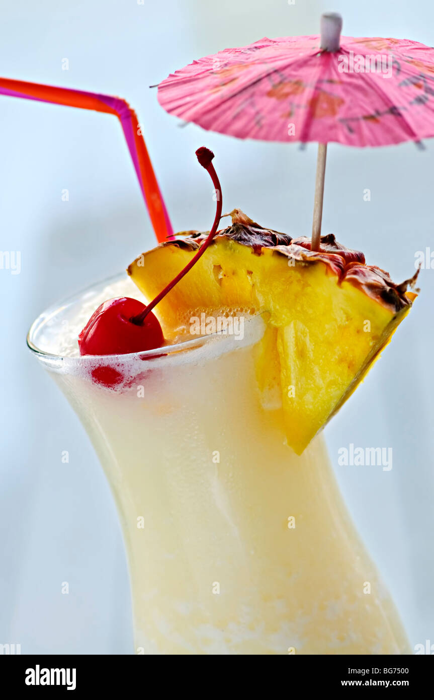 Pina colada drink in hurricane cocktail glass isolated on white background Stock Photo