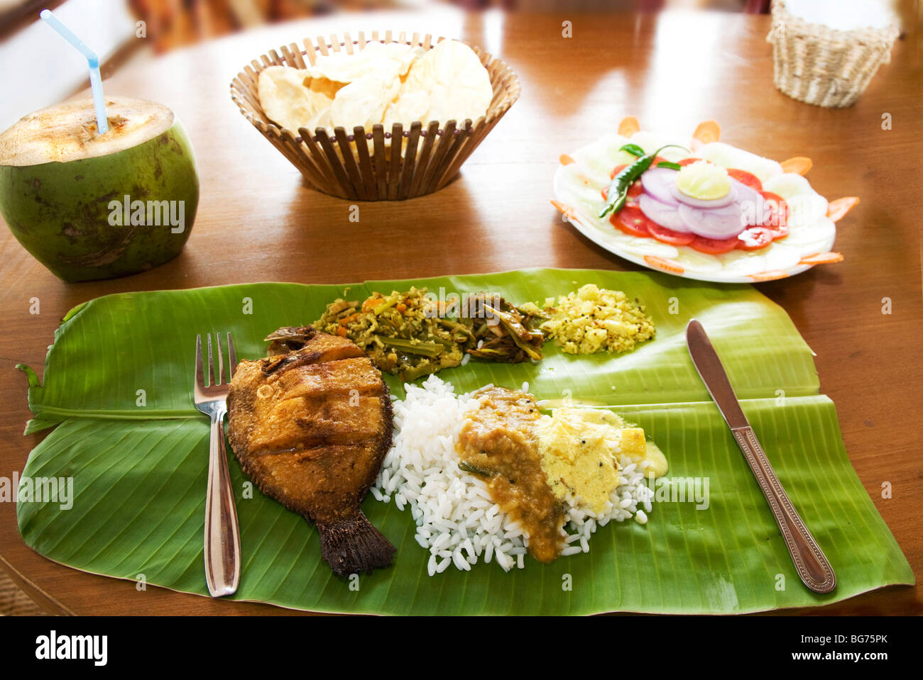 Rice Dish with fish and curry served on palm leaf,Kerala, India Stock