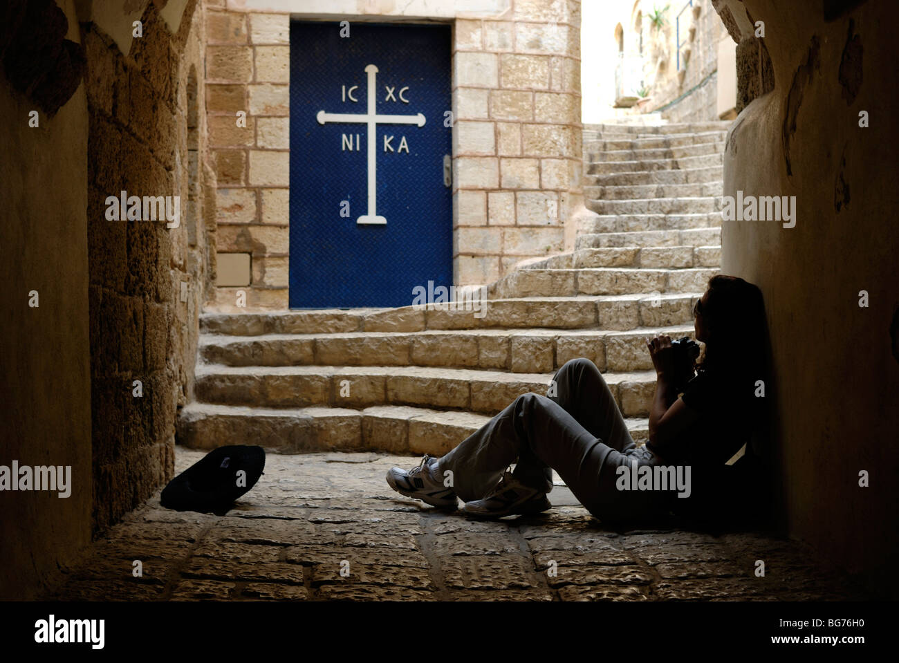 Israel, Tel Aviv, Jaffa, people in a Narrow alleyway next to the door to the Greek Orthodox Church Stock Photo