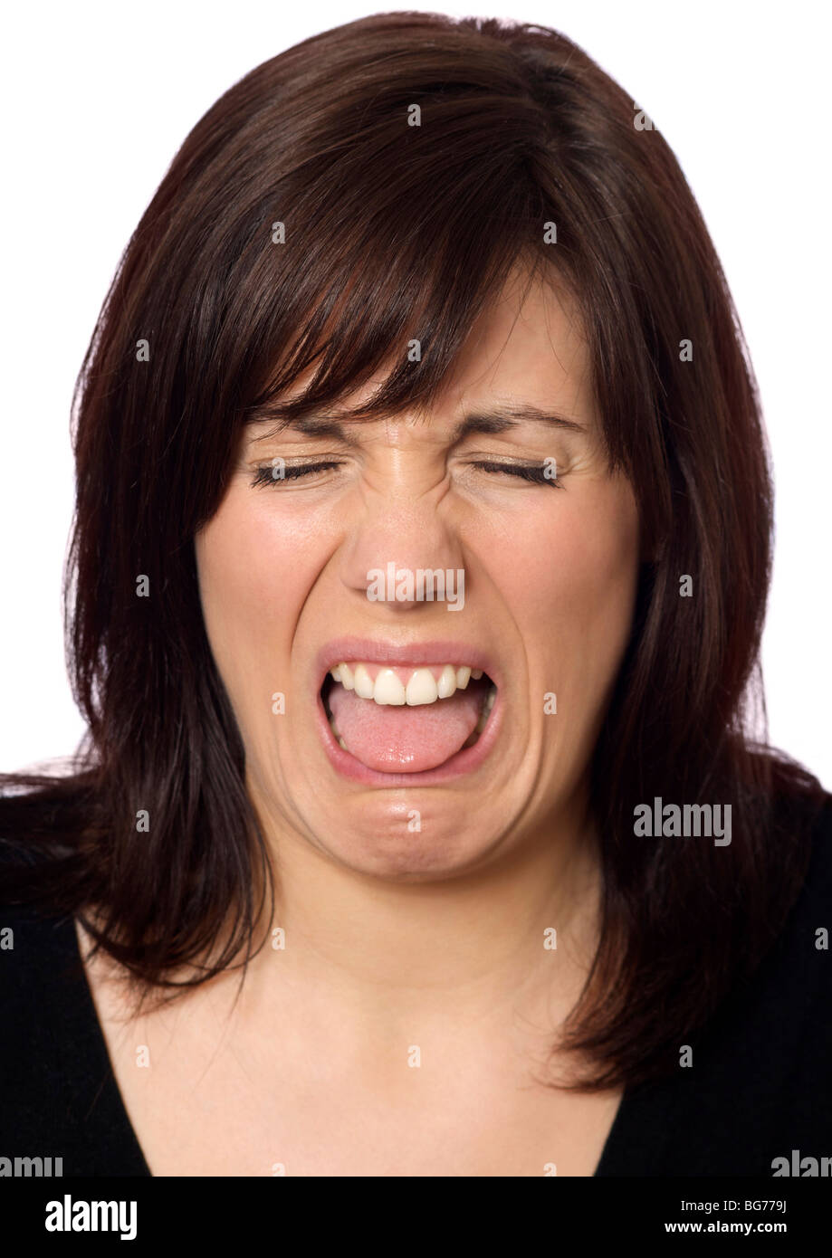 woman with a nasty taste in her mouth pulling a face Stock Photo