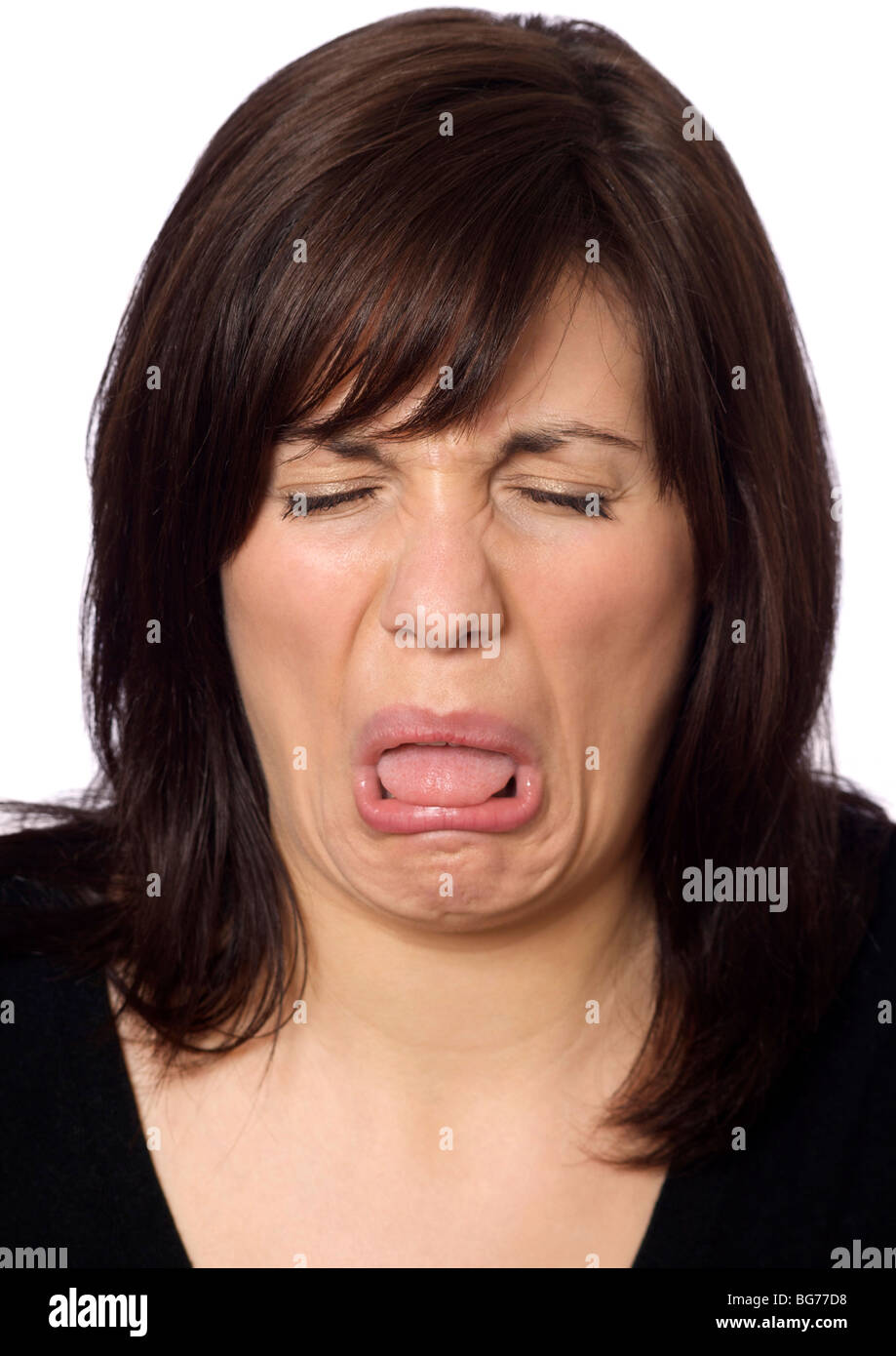 woman with a nasty taste in her mouth pulling a face Stock Photo