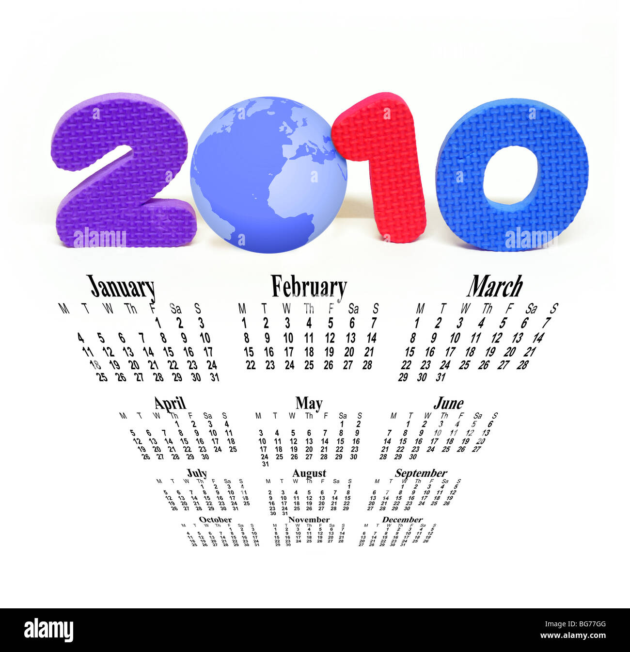 The year 2010 made up with plastic numbers and planet earth with a descending view of the months of the year. Stock Photo