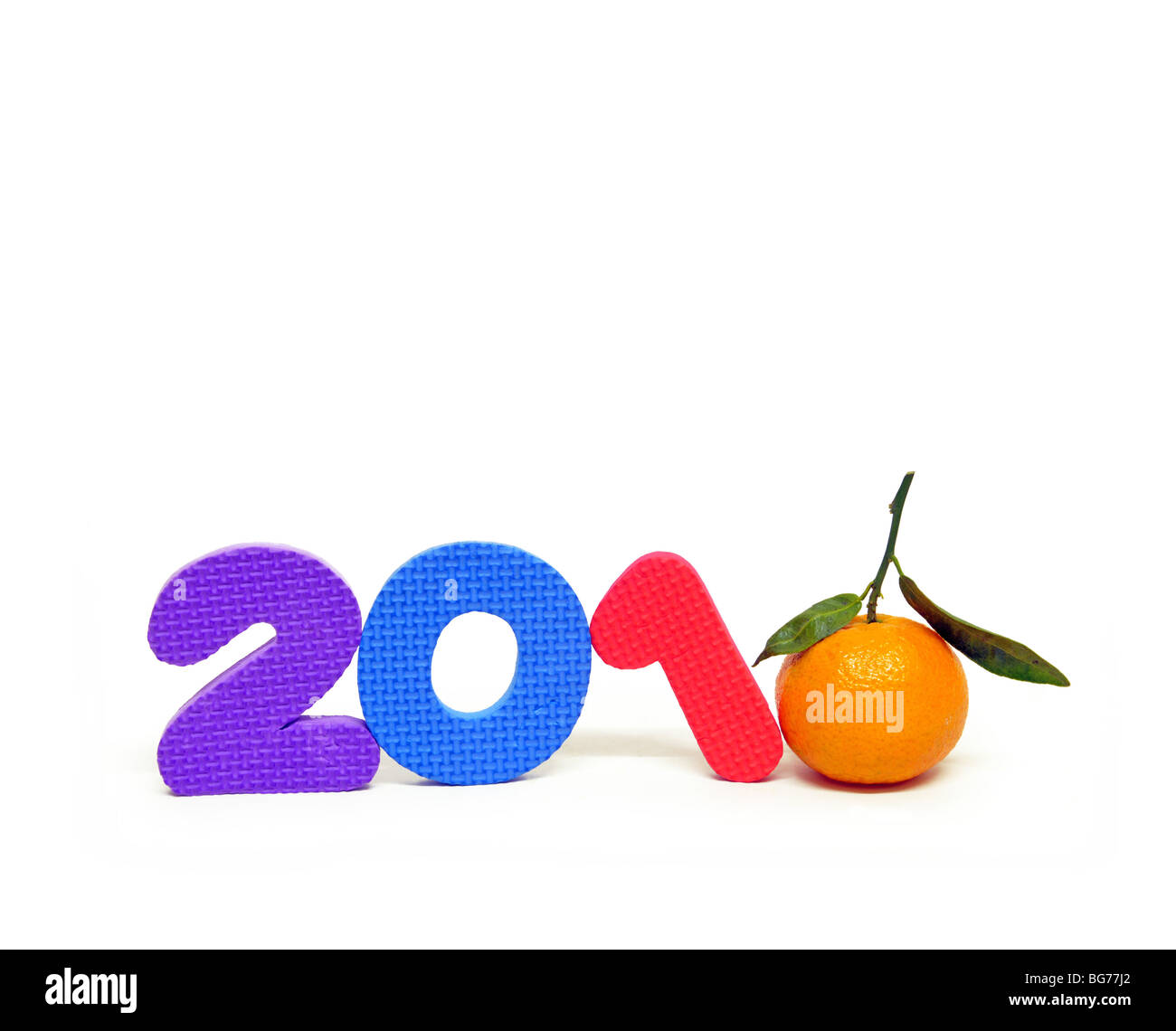 Still life of toy numbers and an orange creating the year 2010. Stock Photo