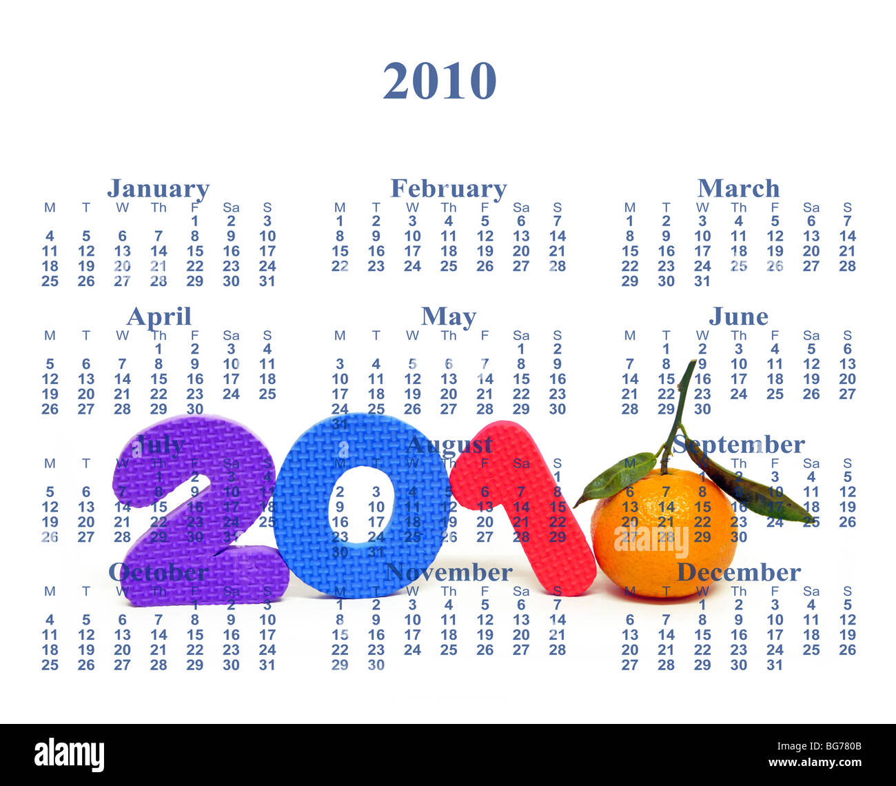 Still life of toy numbers and an orange creating the year 2010 with calendar months and dates superimposed on it. Stock Photo