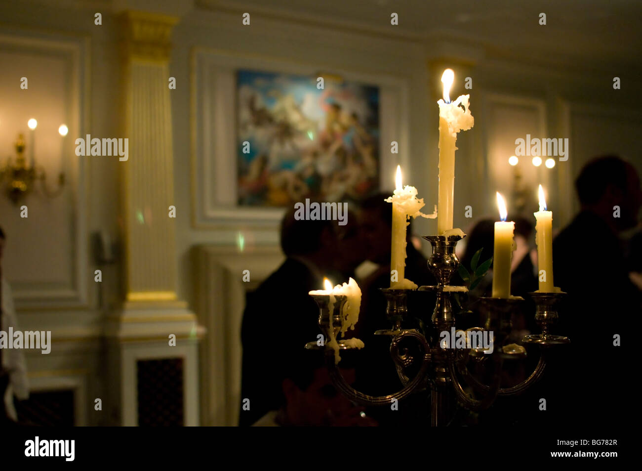 Candles alight in a candelabra in a function room Derbyshire England