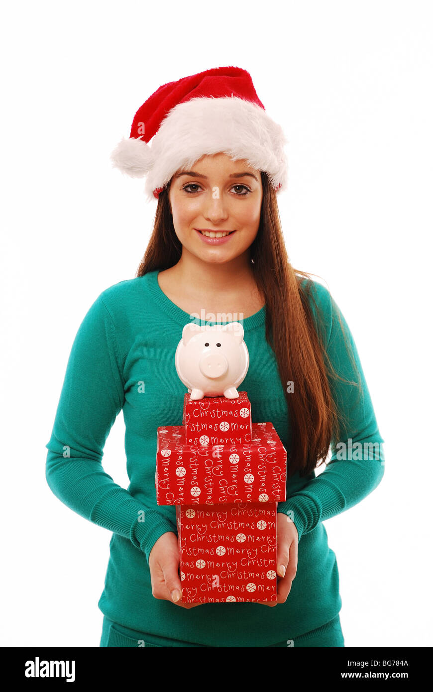 Young girl holding Christmas presents and a pig money box Stock Photo ...