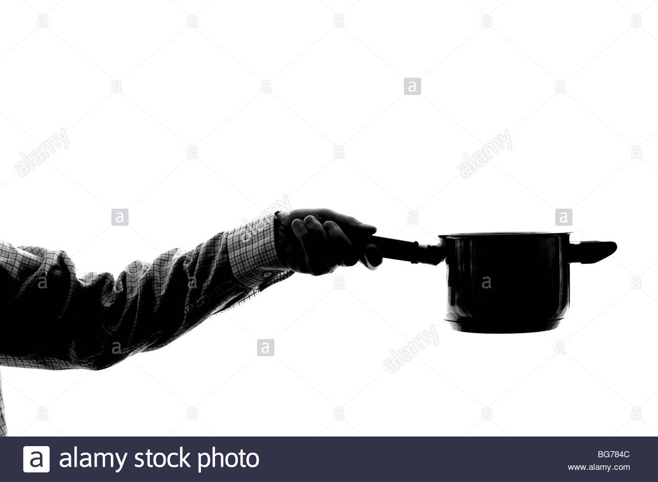 Silhouetted man holding saucepan Stock Photo