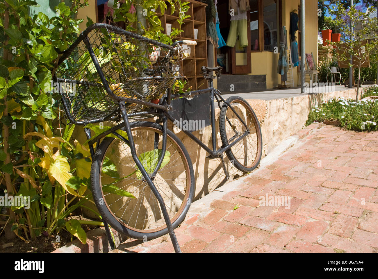 An old delivery bicycle outside a shop in the picturesque village of Riebeek Kasteel in the Western Cape, South Africa. Stock Photo