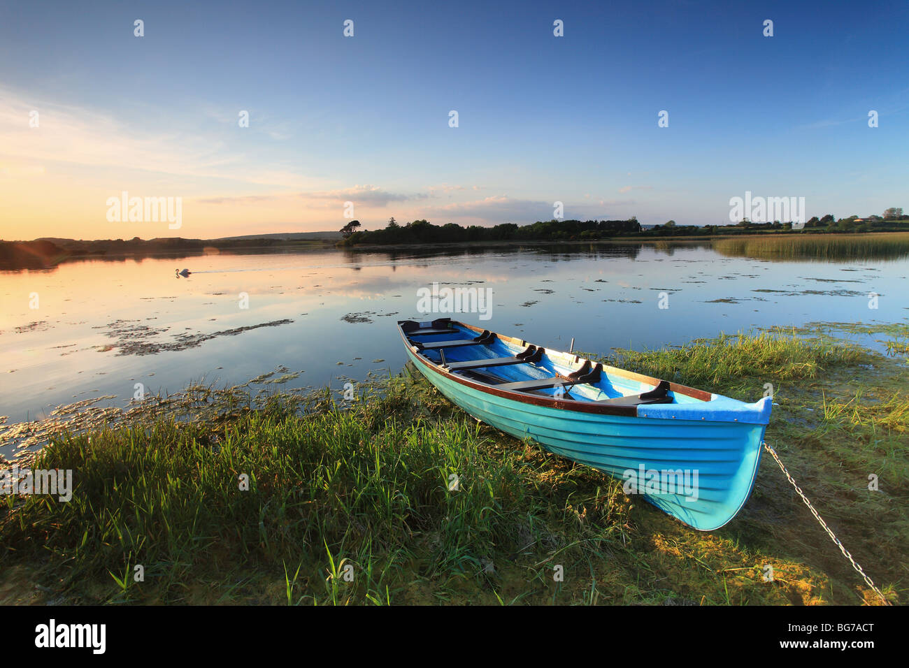 Blue rowing boat on the shore of Lake Inchiquin, County Clare, Ireland. Stock Photo