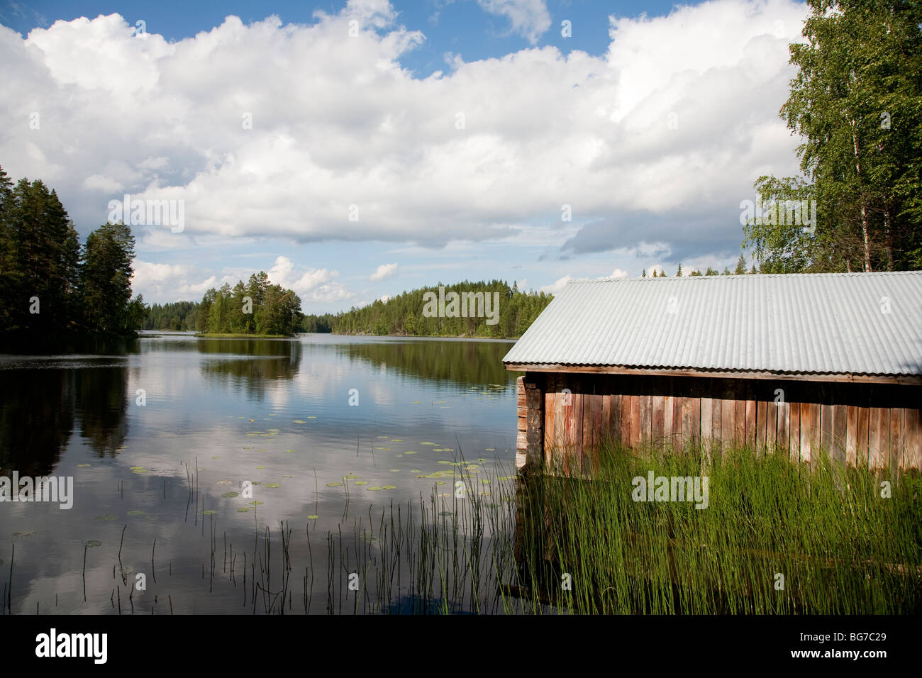 Old Finnish boathouse , made of logs , at lake Konnevesi shore , Finland Stock Photo