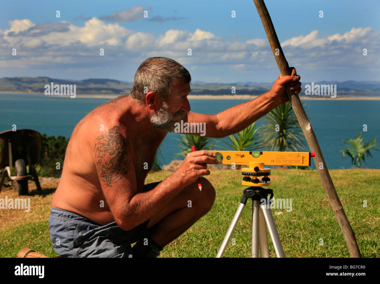 A man uses a Laser Level during construction Stock Photo