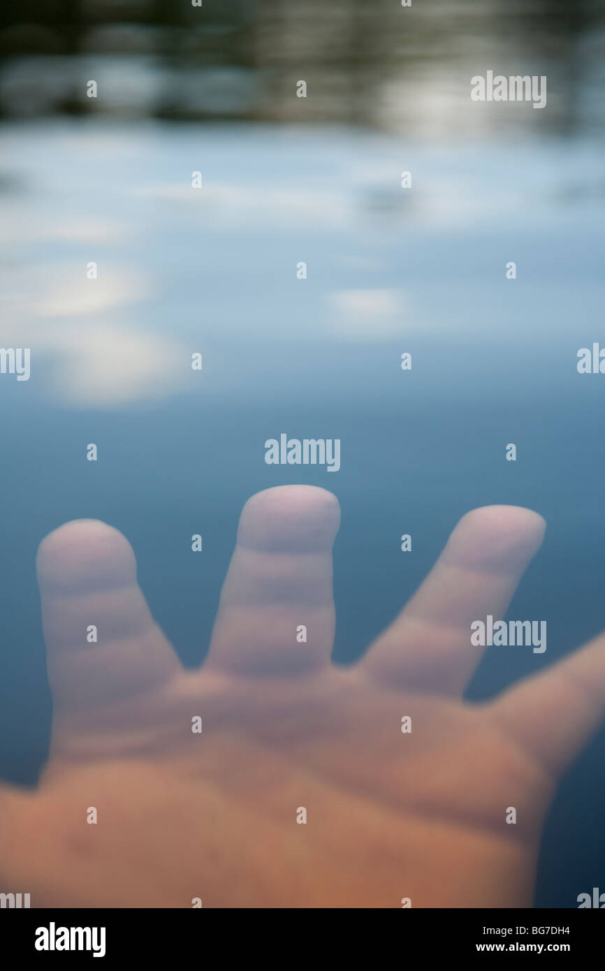 Hand submerged under water surface fingers spread Stock Photo Alamy