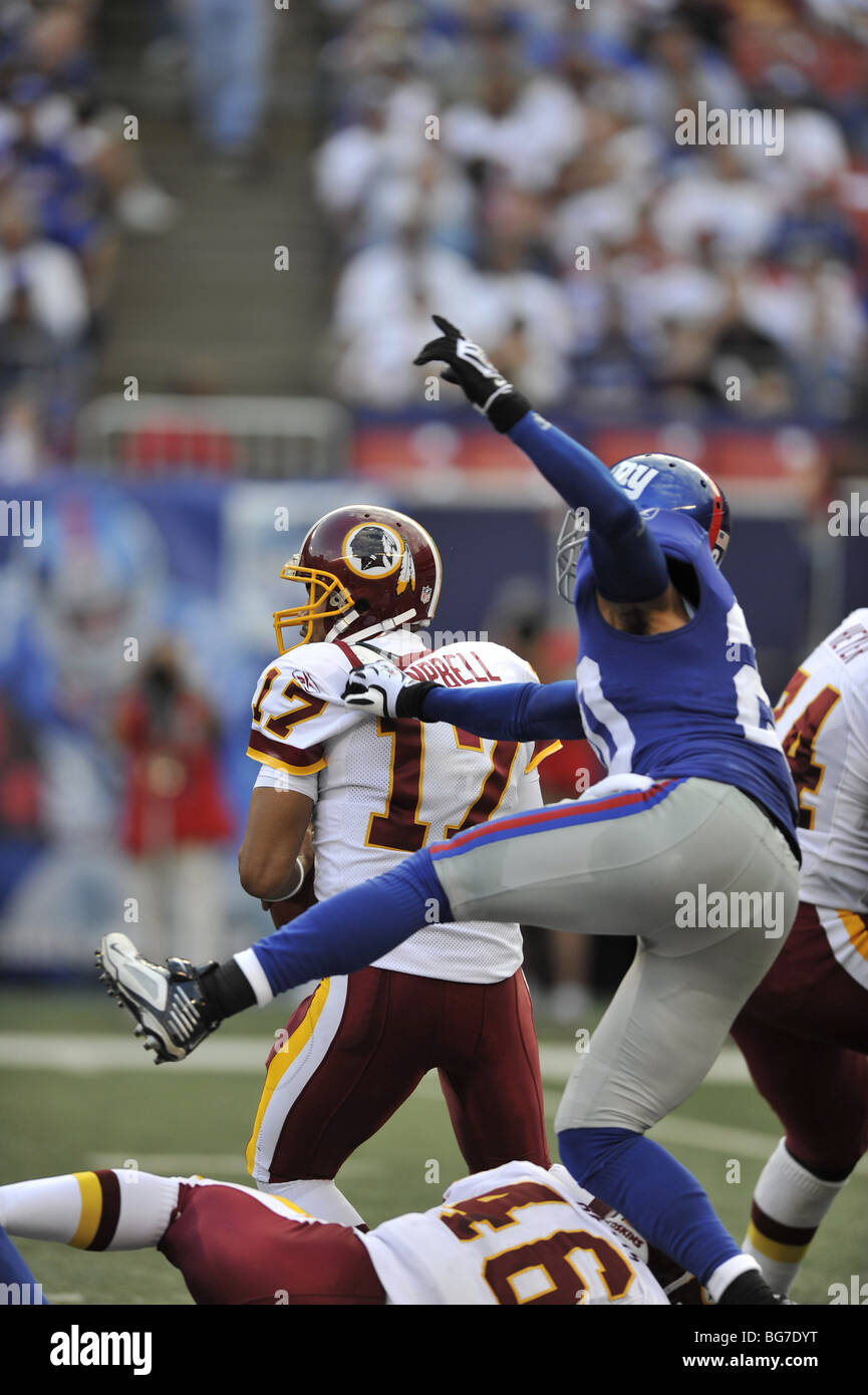 Jason Cambell of the Washington Redskins gets the pass the football while under pressure from the New York Giants defense Stock Photo