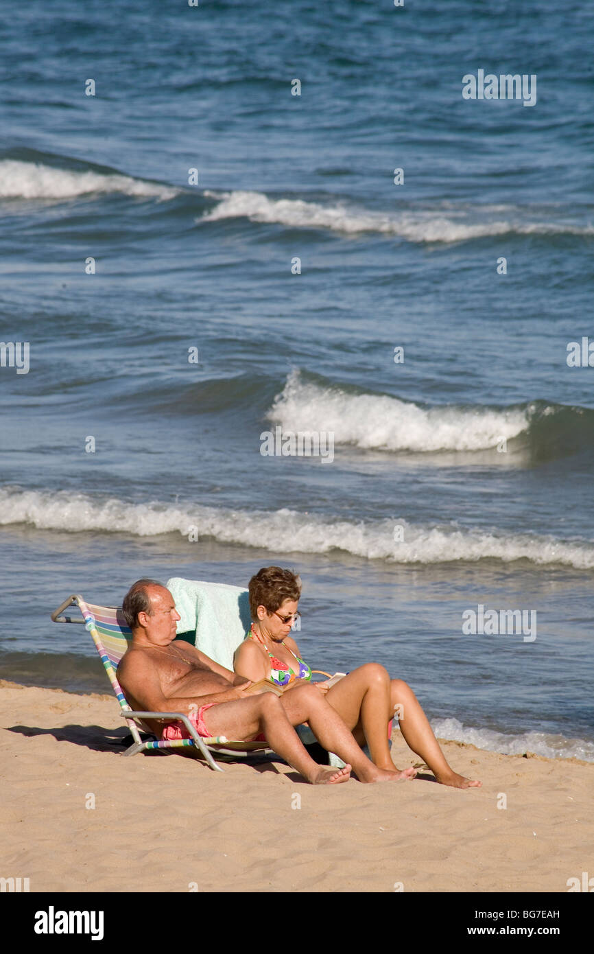 Old wife nudist mature couple  Old couple reading sunbathing beach hi-res stock photography and images -  Alamy