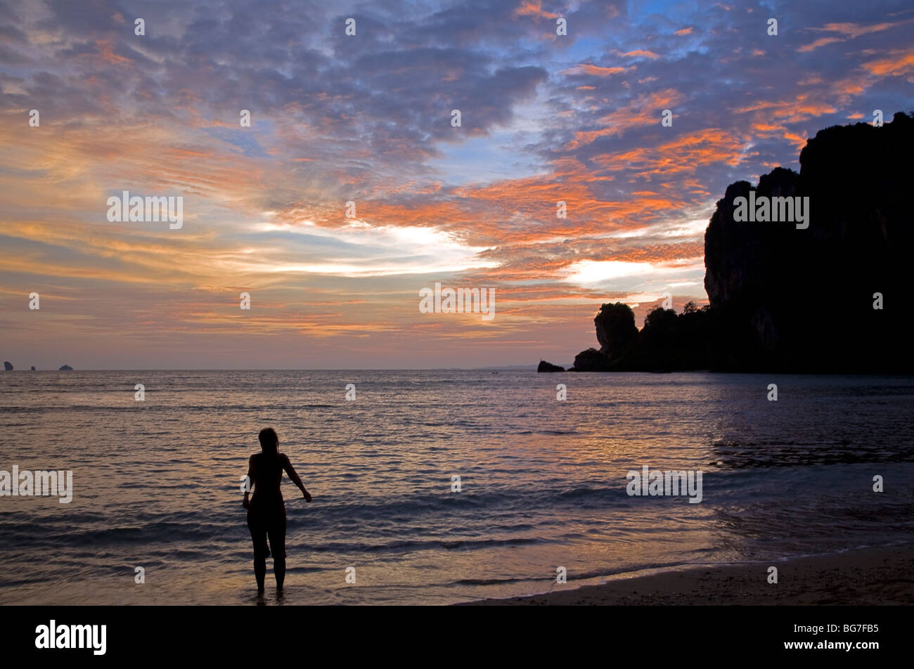 Woman relaxing and contemplating the sunset. Hat Ton Sai. Krabi Province. Thailand Stock Photo