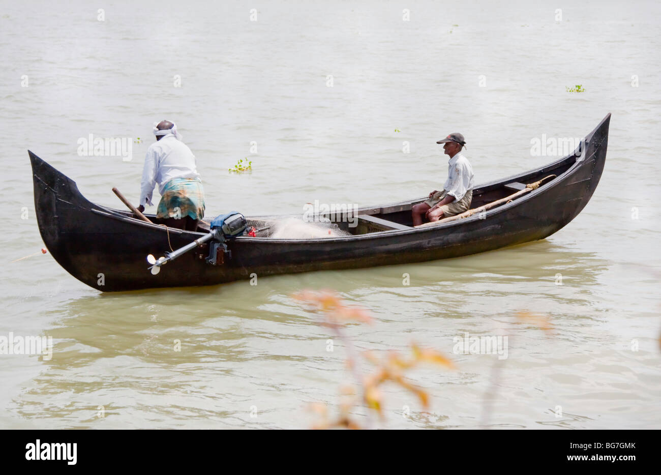 Two fishermen in a fishing boat in Kerala Stock Photo - Alamy