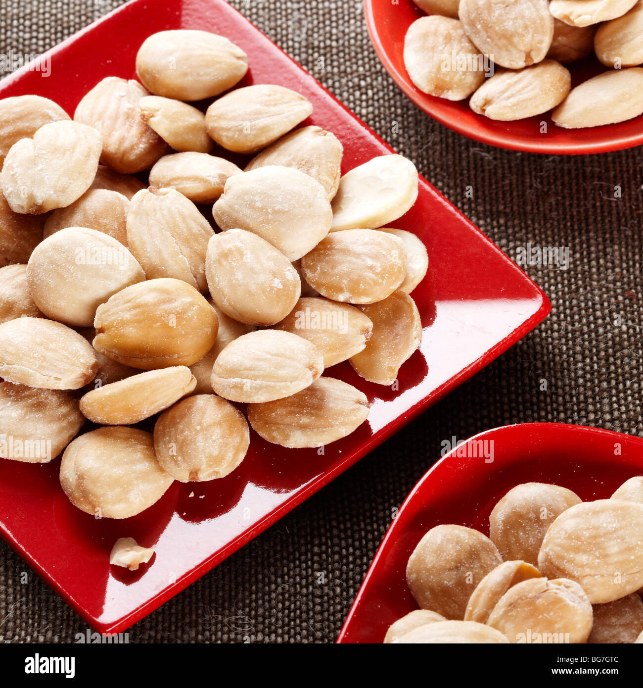 Spanish almonds salted red dish serving party food Marcona Stock Photo