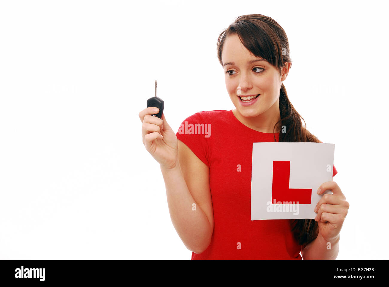 Young girl holding a car key and L Plate sign Stock Photo