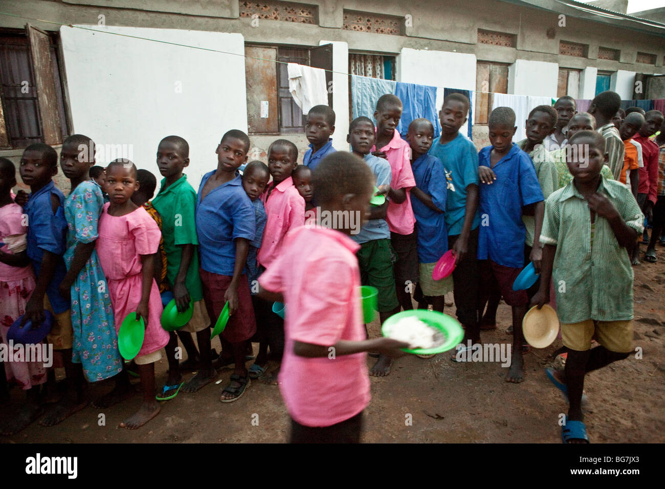 Children stand in a food distribution line in an orphanage in Amuria, Eastern Uganda. Stock Photo