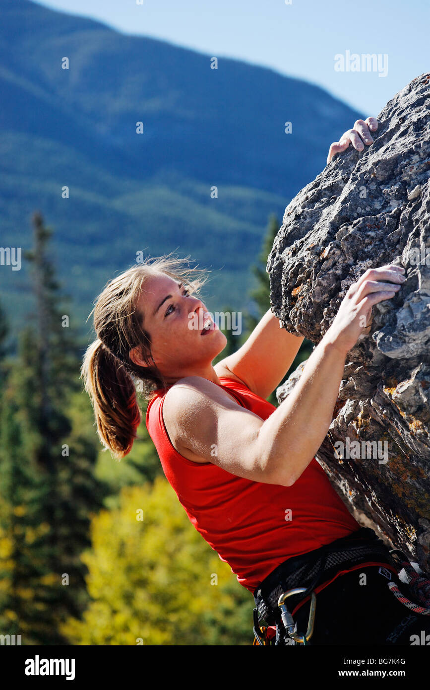 Female climber climbing overhanging rock face, Banff, Banff National
