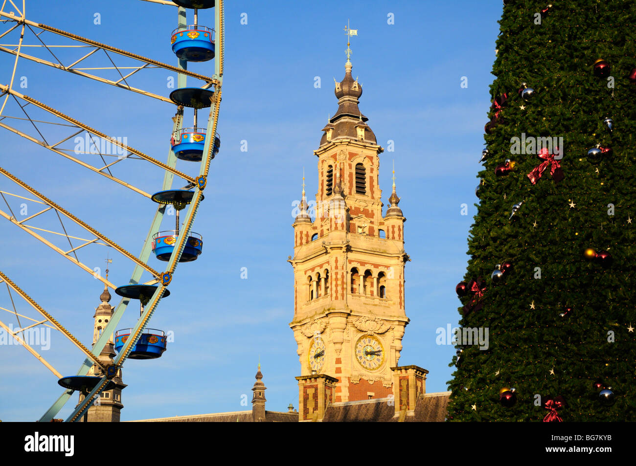 Lille, Pas de Calais, France. Ferris wheel, Town Hall tower and Christmas Tree at the Christmas Market Stock Photo