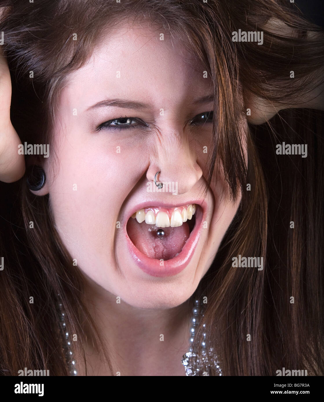 an alternative punky girl screams in anger Stock Photo