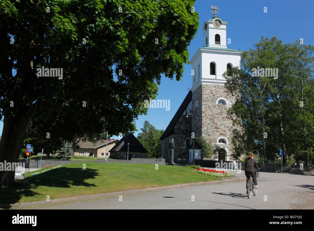 Finland, Region of Satakunta, Rauma, Historic Church, 15th-Century Stone Church of Holy Cross, Cyclist Stock Photo