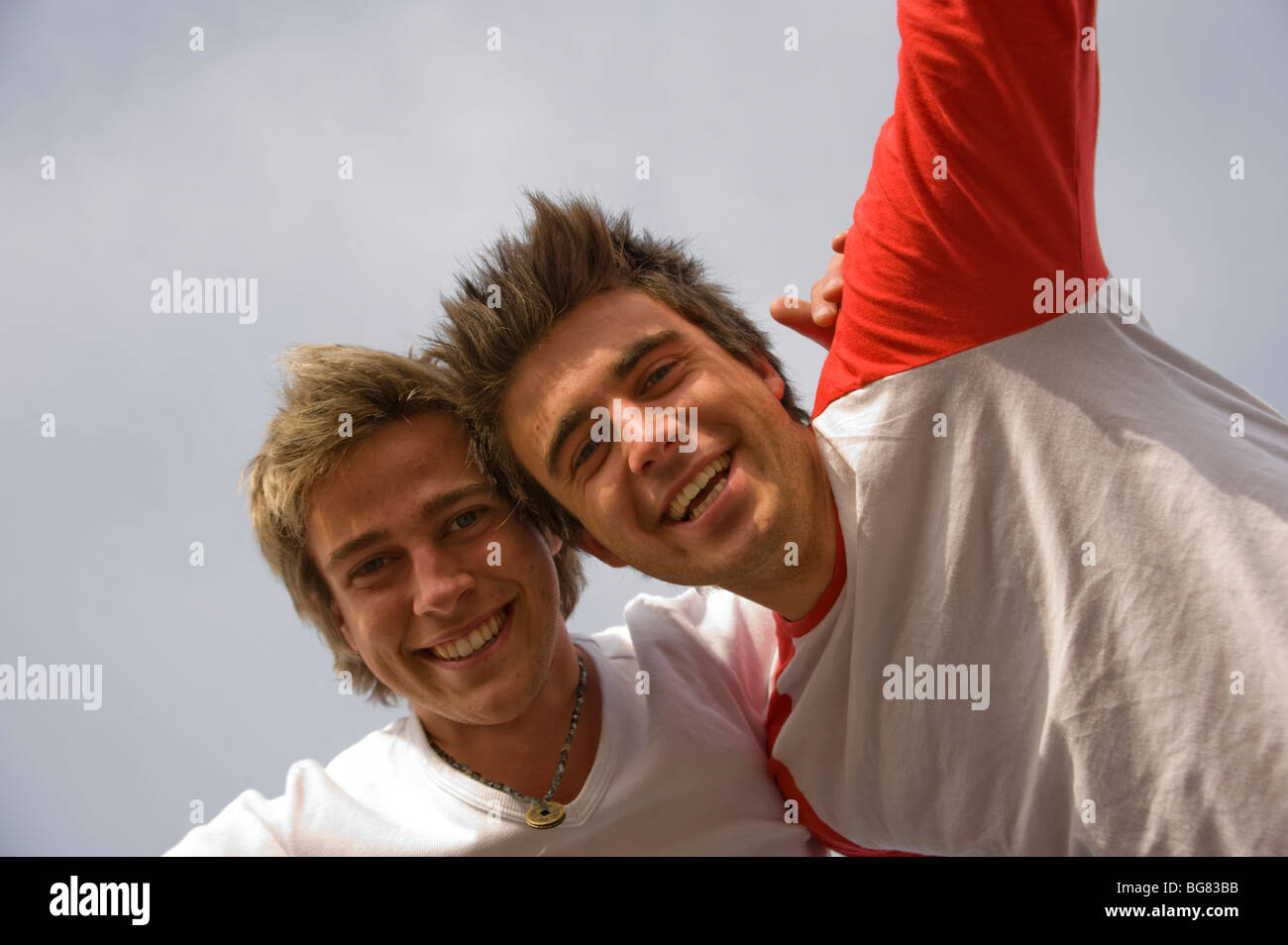 2 teenage boys smiling into camera with their arms around each other ...