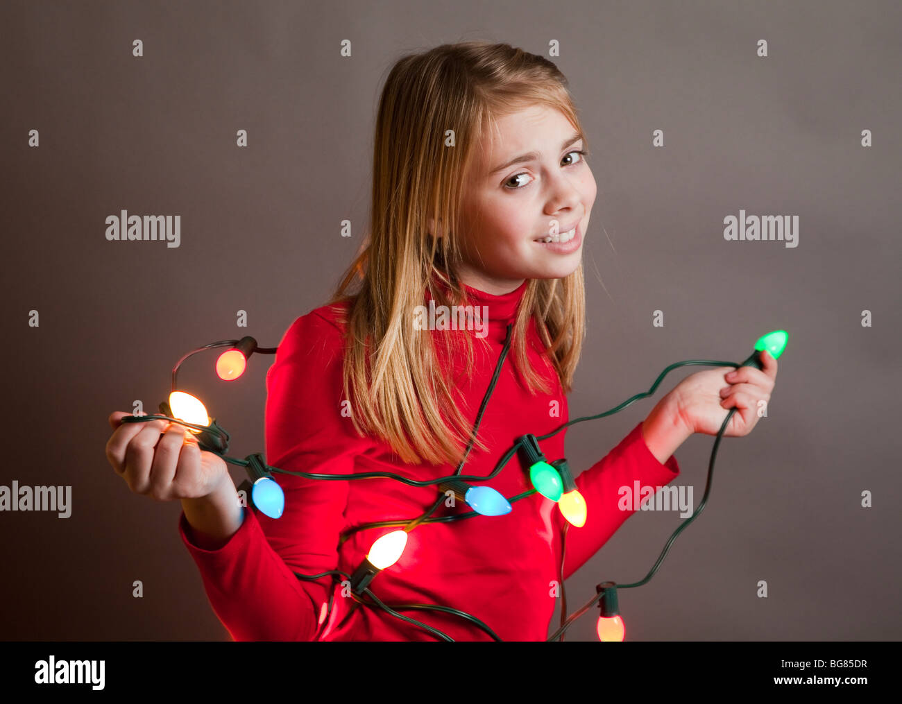 Child holding string of Christmas lights Stock Photo Alamy