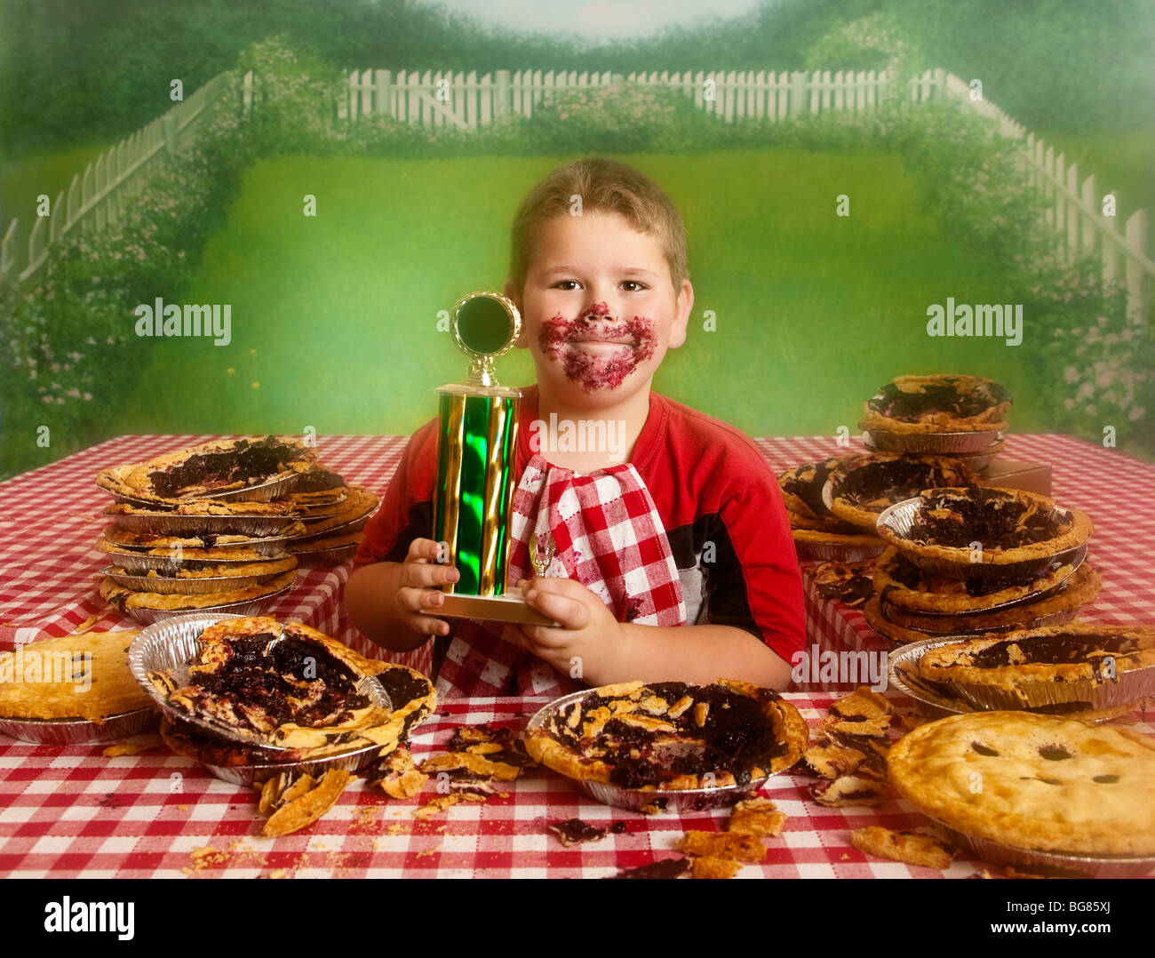 Chubby Boy at the end of a pie eating contest with the winning medal