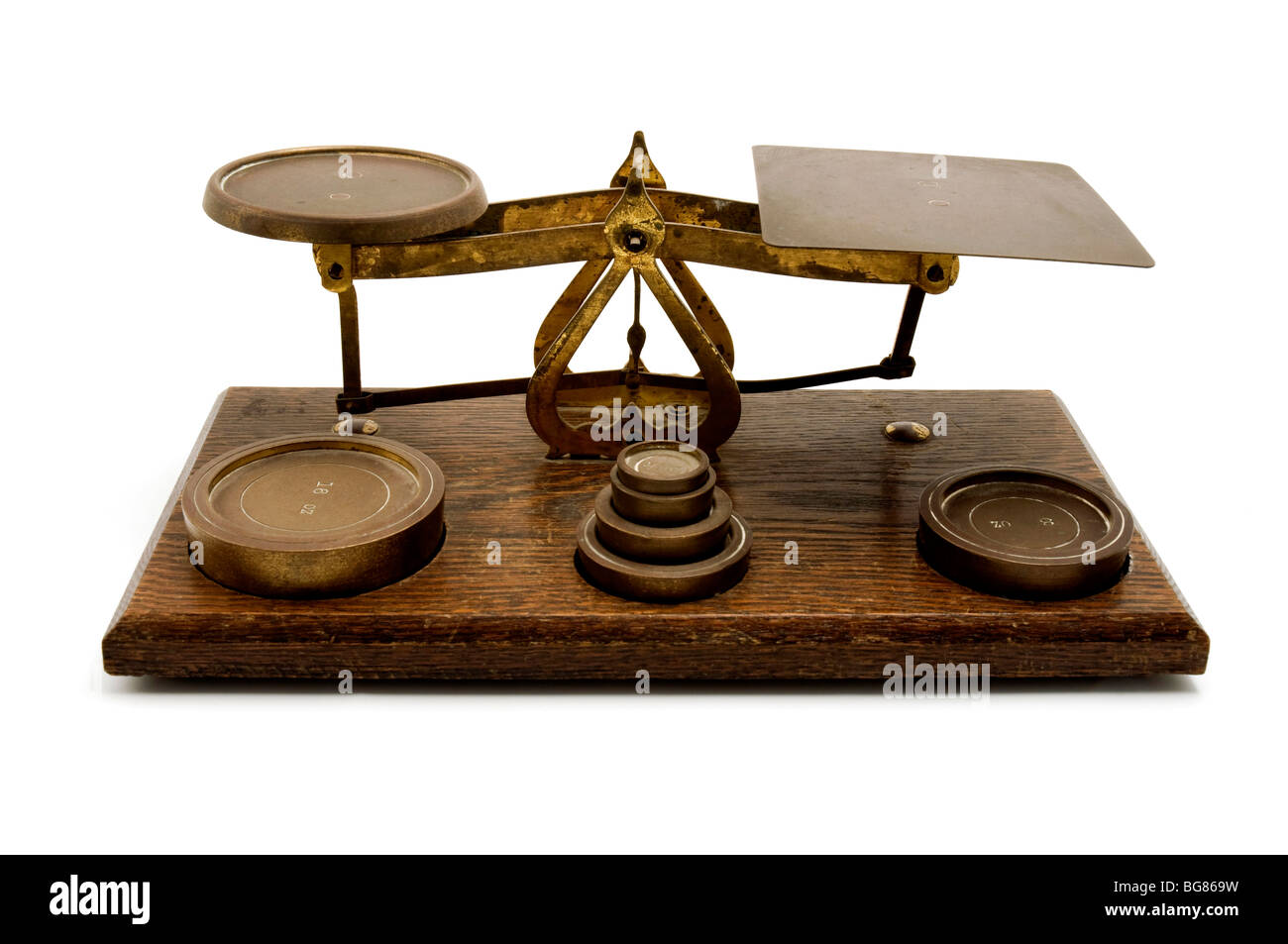 An old two pan balance with weights on a white background Stock Photo