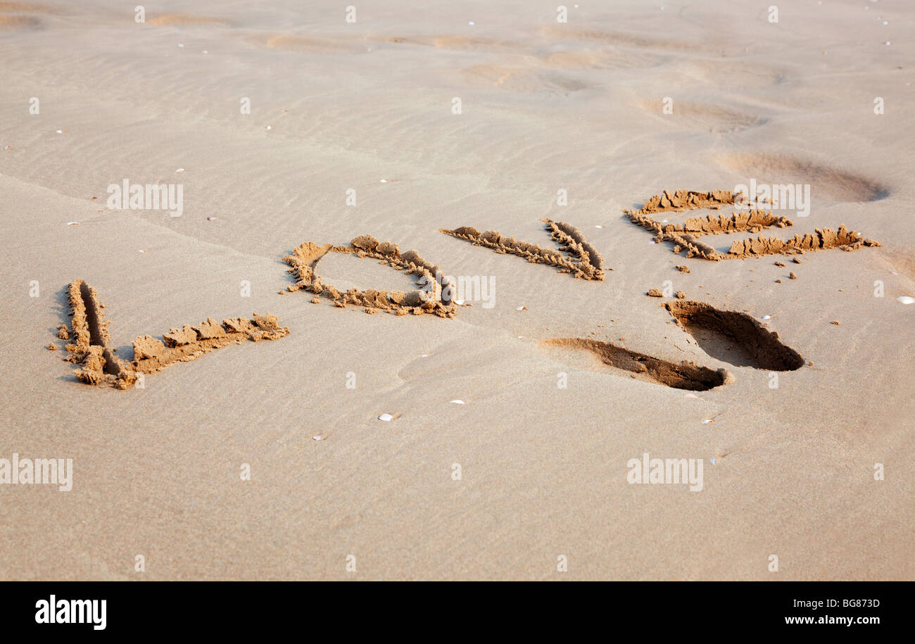 Love written in the sand on a beach Stock Photo - Alamy