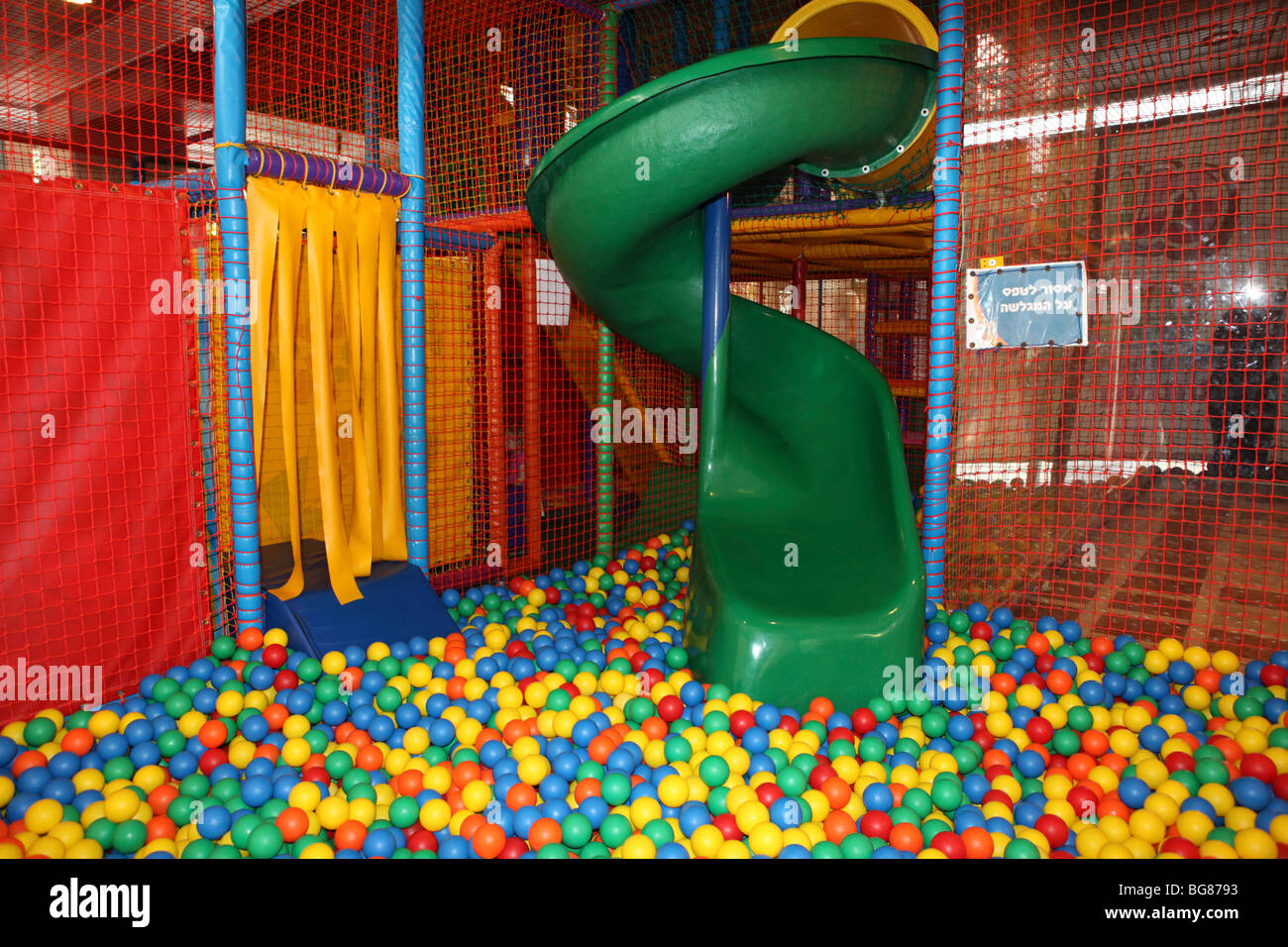 Indoor children's playground a slide in an empty ball pool Stock Photo