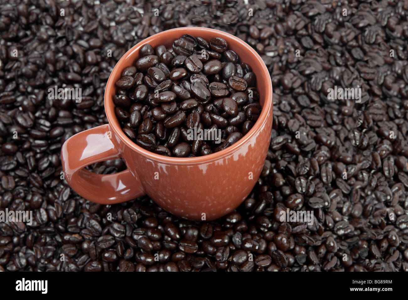 Coffee mug full of coffee beans Stock Photo Alamy