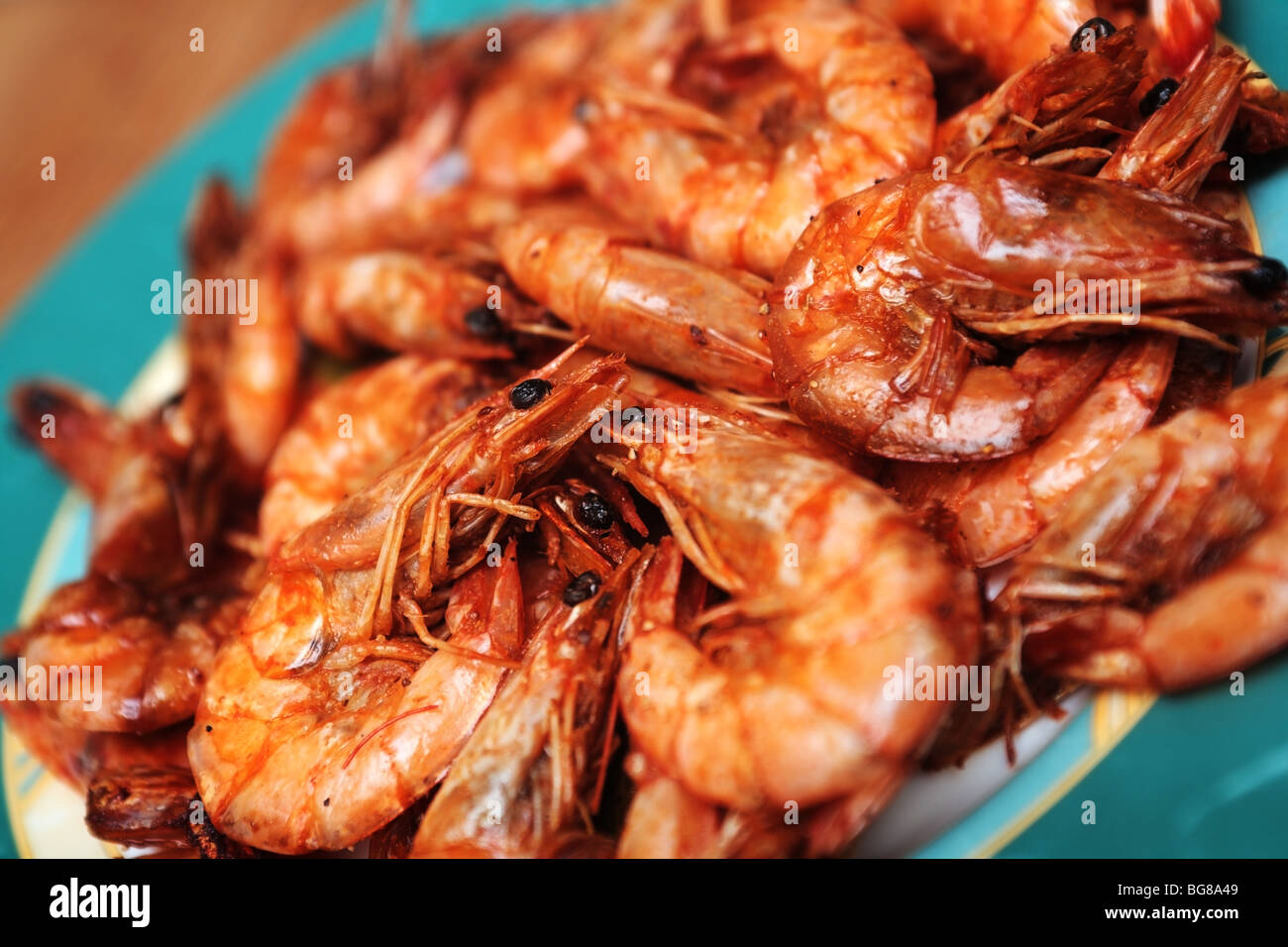 Fried shrimps with a pepper in a soy-bean sauce on a dish. Stock Photo