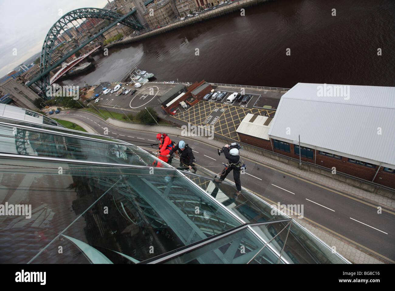 BBC 'Blue Peter' presenter Joel Defries window cleaning for the program at the Sage Gateshead in