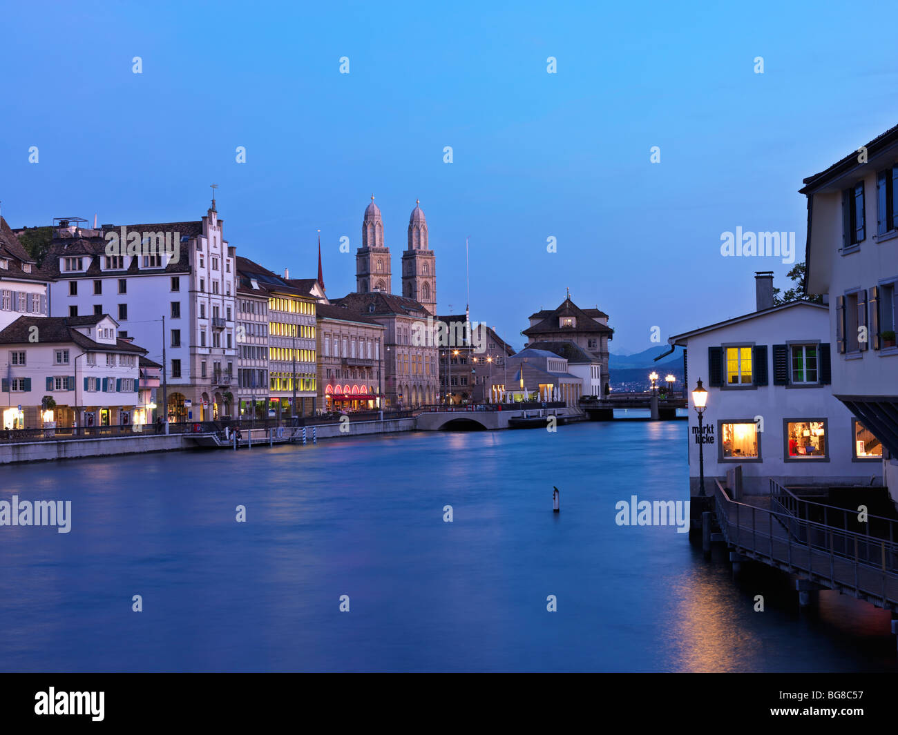 Switzerland, Zurich,Old Town Zurich and Limmat River front with Grossmunster Church at dusk Stock Photo