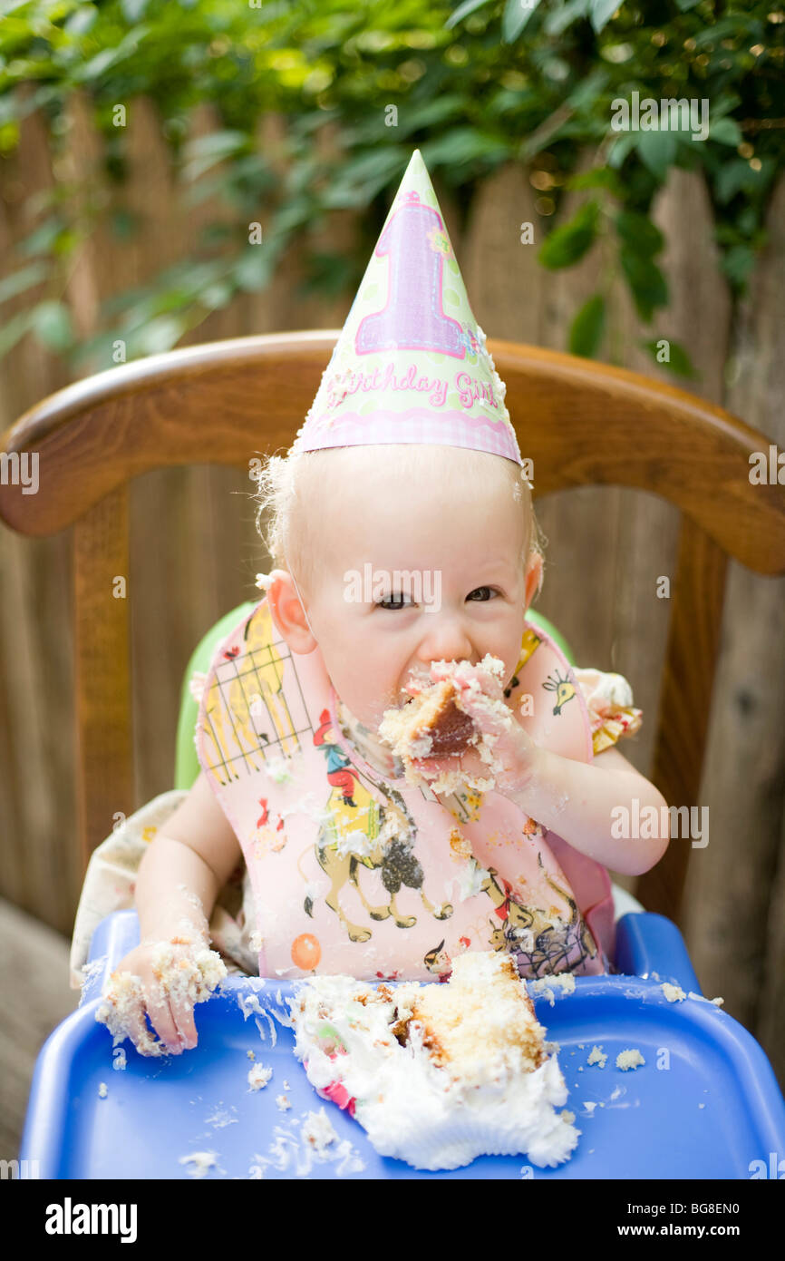 A baby girl celebrates her birthday by eating cake in Philadelphia, Pennsylvania Stock Photo