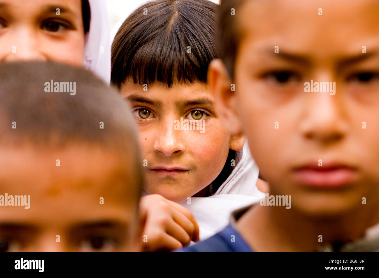 Children's faces as they wait for school to start in Kabul. Stock Photo