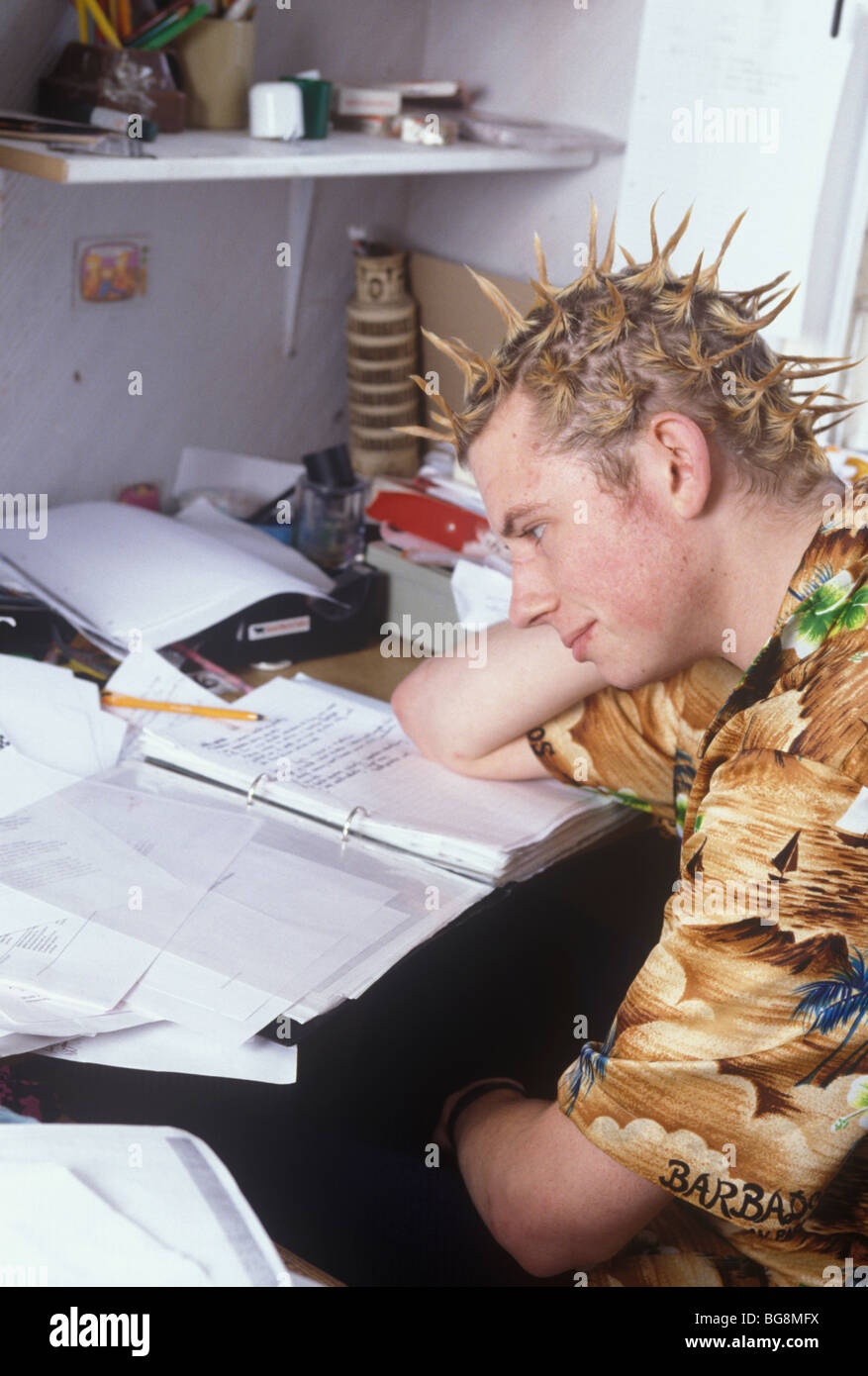 teenage boy with spikey hair style studying Stock Photo