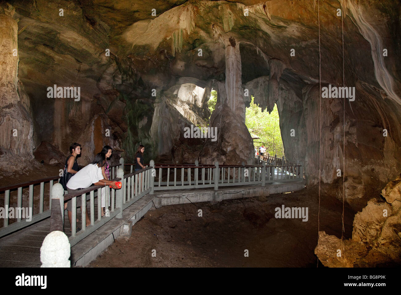 Langkawi Geopark, Malaysia, Bat cave granite interior with tourists on walkway Stock Photo