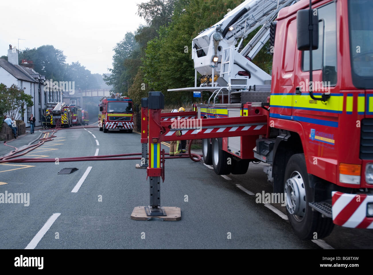 Fire engines in country lane blocking road Stock Photo